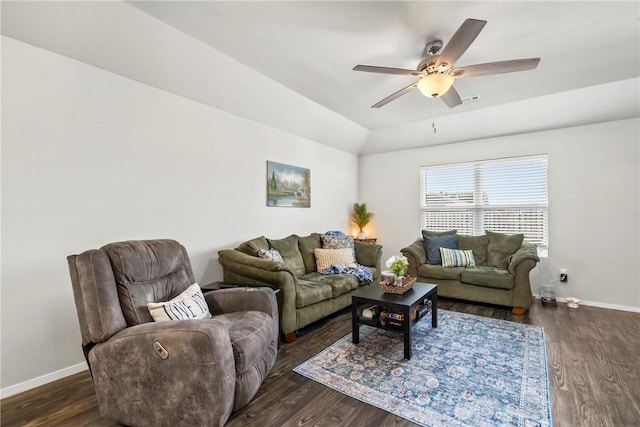 living room with ceiling fan, dark hardwood / wood-style flooring, and vaulted ceiling