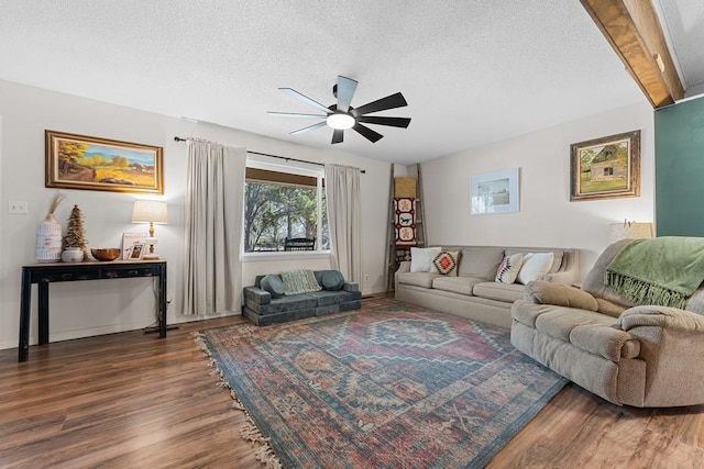 living room featuring hardwood / wood-style floors, a textured ceiling, and ceiling fan