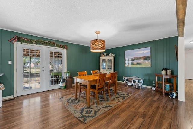 dining area with french doors, dark hardwood / wood-style floors, and a textured ceiling