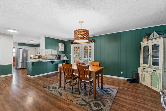 dining space featuring dark hardwood / wood-style floors and a textured ceiling