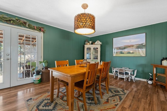 dining space with french doors and dark wood-type flooring