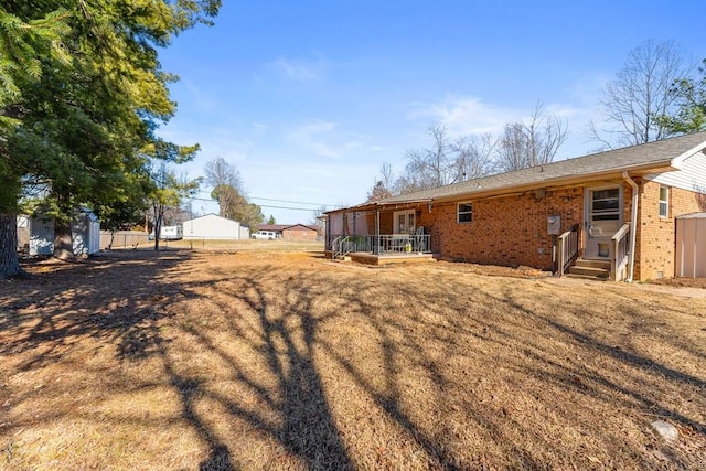 back of house featuring a lawn