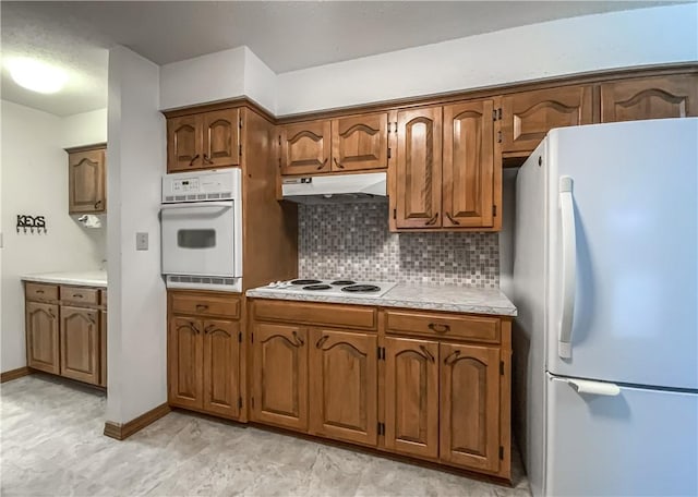 kitchen featuring white appliances and decorative backsplash