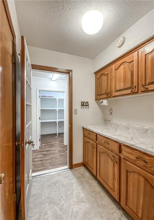 kitchen with light stone countertops and a textured ceiling