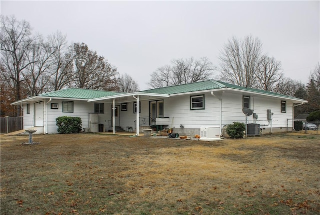 view of front facade with a front yard, covered porch, and central air condition unit