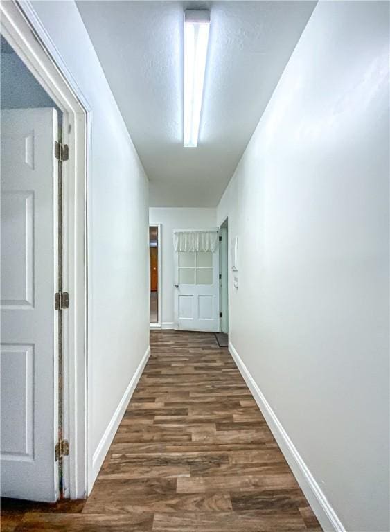 hall featuring dark hardwood / wood-style flooring and a textured ceiling