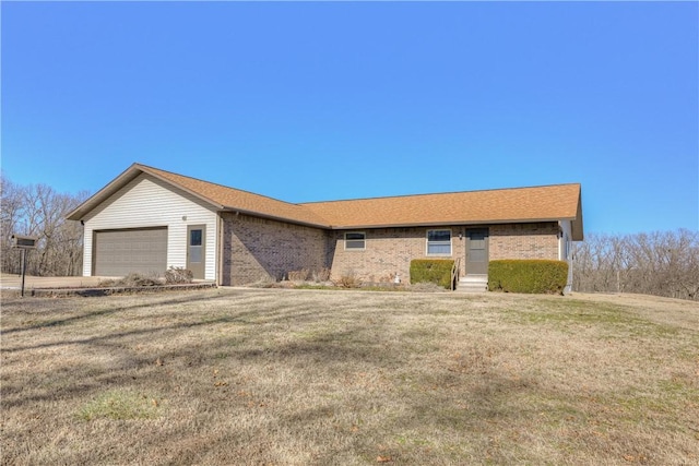 single story home with a garage and a front lawn