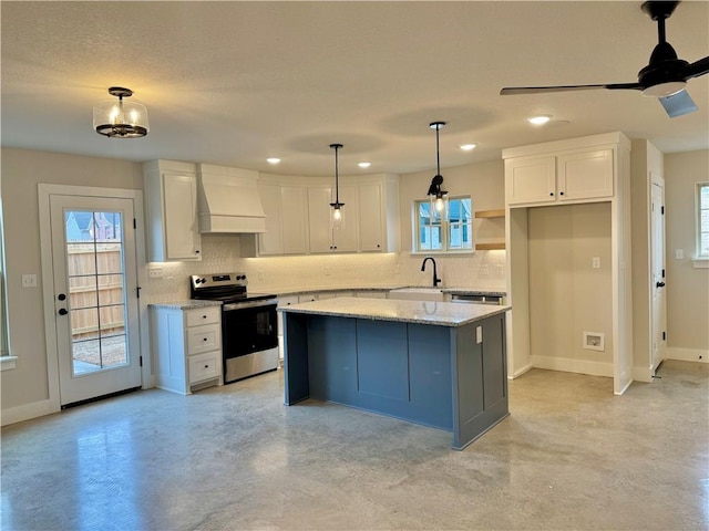 kitchen with sink, custom exhaust hood, white cabinetry, electric range, and a kitchen island