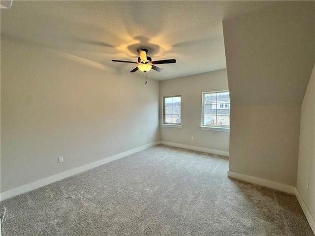 empty room featuring ceiling fan, carpet flooring, and a textured ceiling