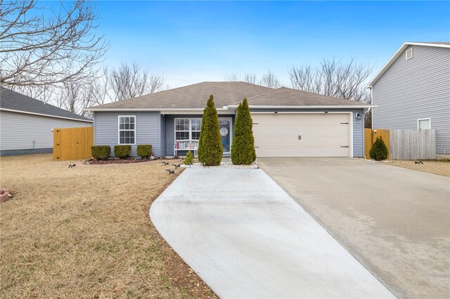 ranch-style home with a garage and a front lawn