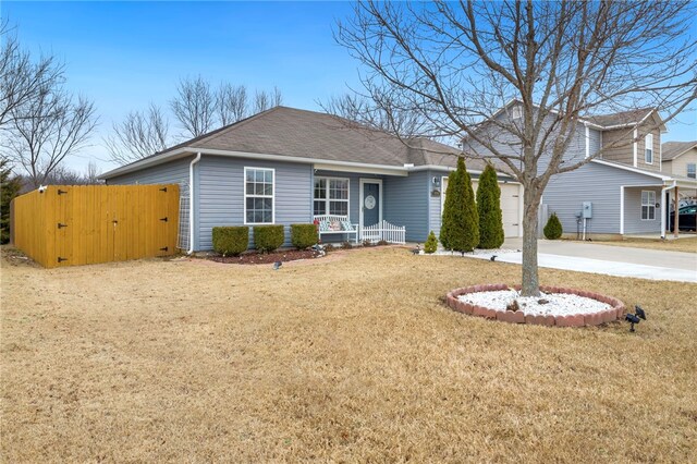 view of front facade with a garage, a front yard, and a porch