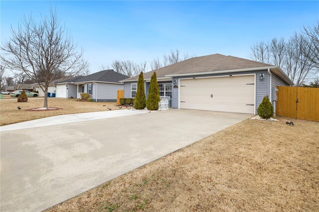 ranch-style house with a garage and a front yard