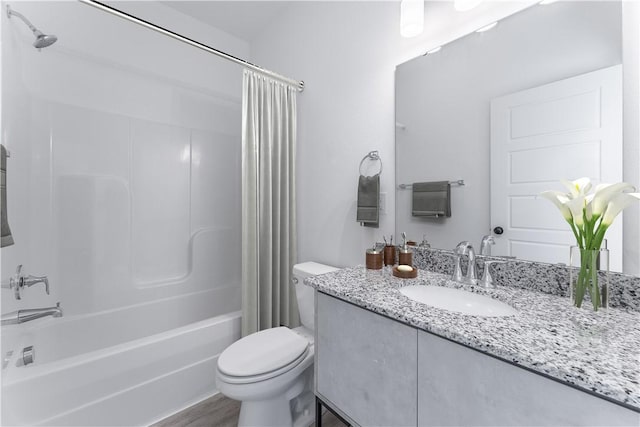 full bathroom featuring hardwood / wood-style flooring, toilet, vanity, and shower / bath combo with shower curtain