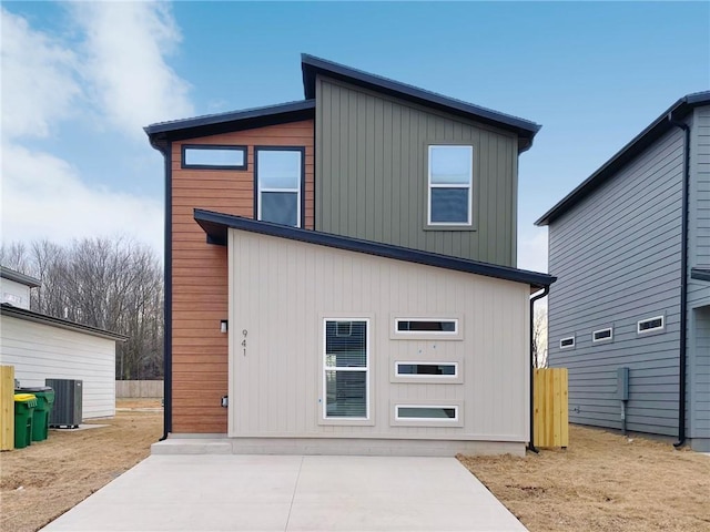 rear view of house featuring central AC unit