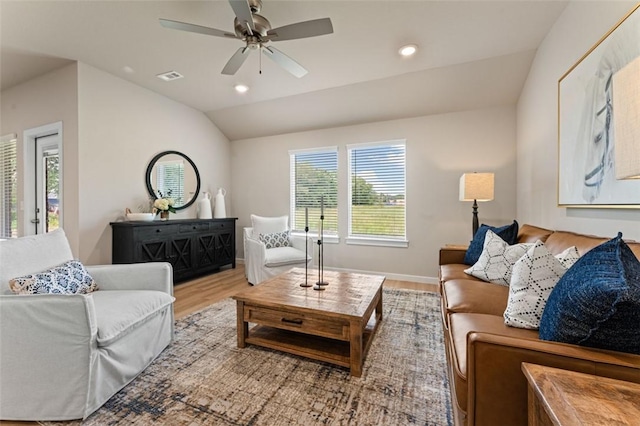 living room featuring light hardwood / wood-style flooring, vaulted ceiling, and ceiling fan