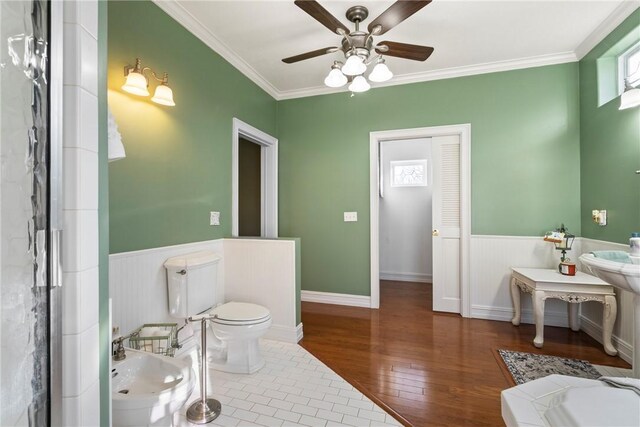 bathroom featuring crown molding, a bidet, plenty of natural light, and wood-type flooring