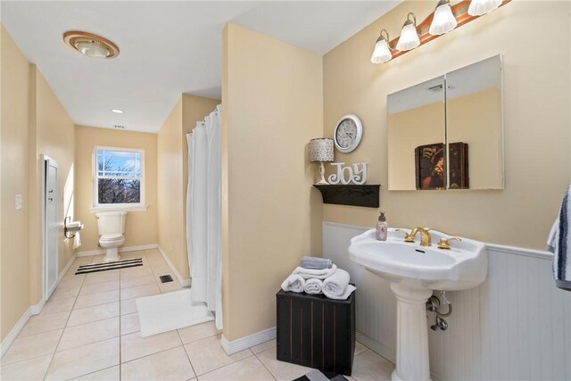 bathroom featuring tile patterned flooring and toilet