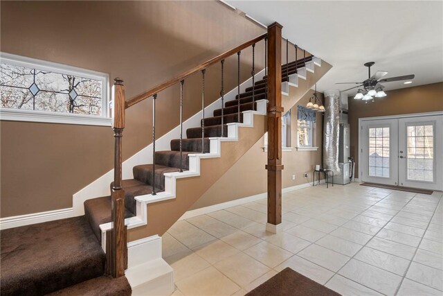 stairs featuring tile patterned floors, french doors, and ceiling fan