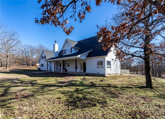 view of property exterior with a porch and a yard