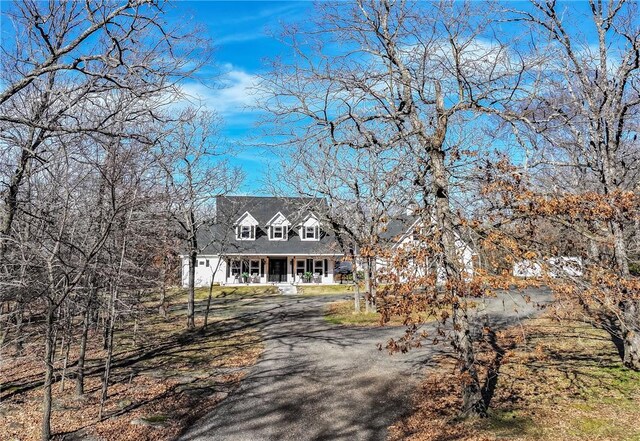 new england style home with covered porch