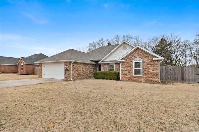 ranch-style house featuring a garage and a front yard