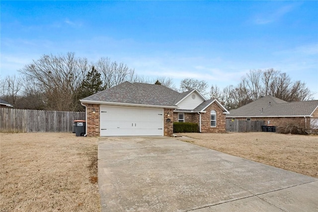 ranch-style home with a garage and a front lawn