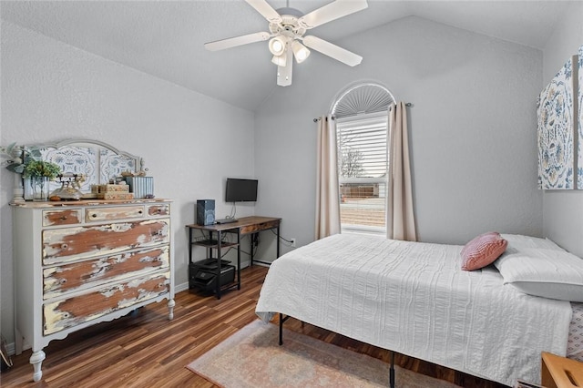 bedroom featuring ceiling fan, lofted ceiling, and wood-type flooring