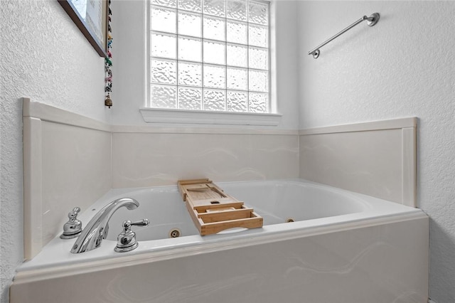 bathroom with a tub to relax in