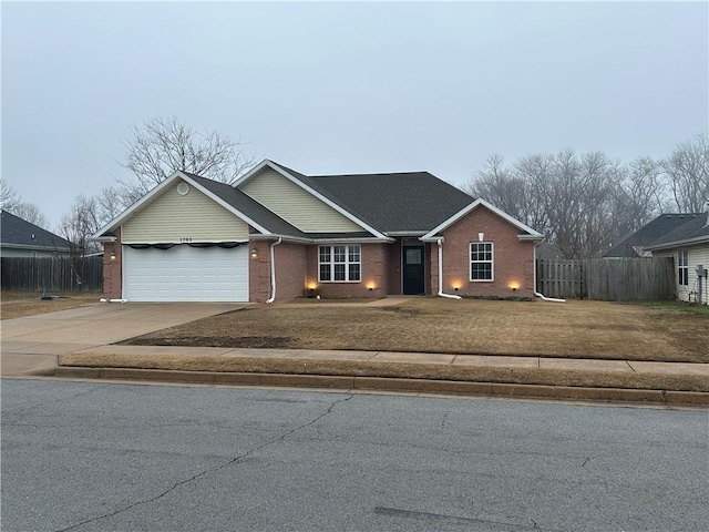 ranch-style home with a garage and a front lawn