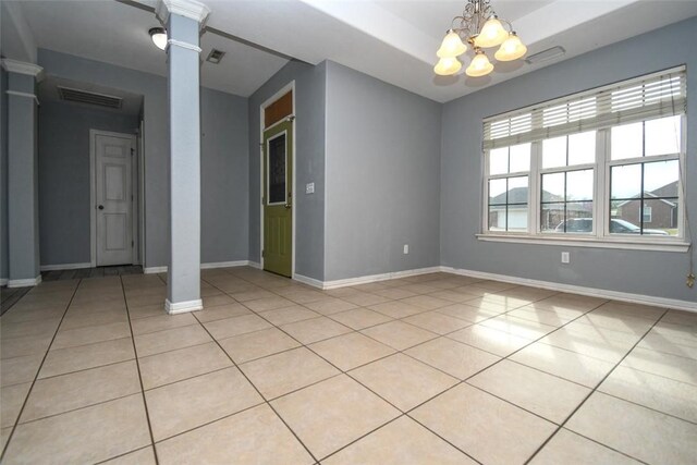 unfurnished room featuring light tile patterned flooring, decorative columns, a chandelier, baseboards, and visible vents