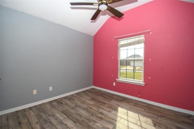 spare room featuring wood finished floors, baseboards, vaulted ceiling, and ceiling fan