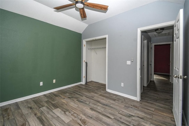unfurnished bedroom with a closet, baseboards, ceiling fan, wood finished floors, and lofted ceiling