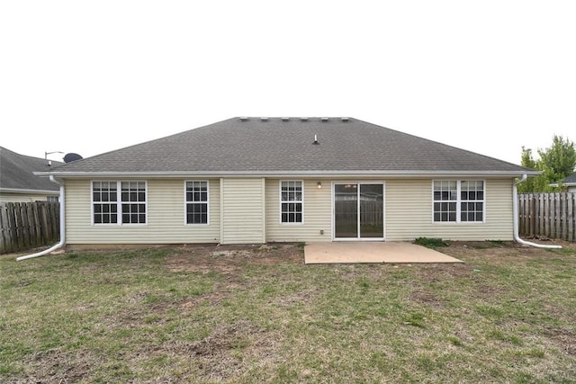 rear view of property with a patio, fence, and a lawn