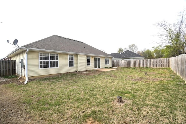 back of property featuring a fenced backyard, a shingled roof, a patio area, and a lawn