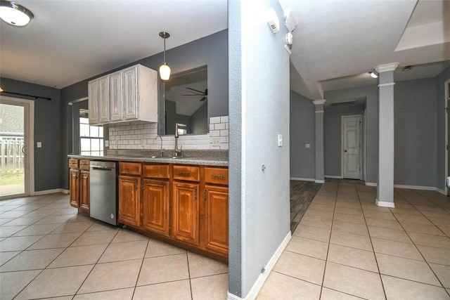kitchen featuring decorative columns, light tile patterned floors, ceiling fan, and stainless steel dishwasher
