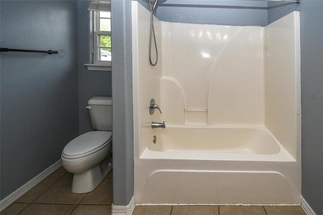 bathroom with baseboards, toilet, and tile patterned floors