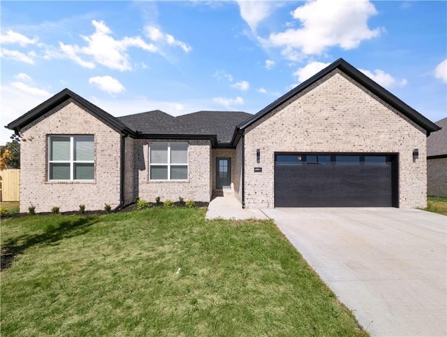 view of front facade with a garage and a front lawn