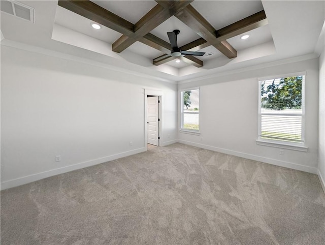 carpeted empty room featuring coffered ceiling, beam ceiling, crown molding, and ceiling fan