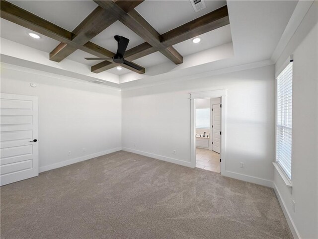 carpeted spare room featuring coffered ceiling, beam ceiling, crown molding, and ceiling fan