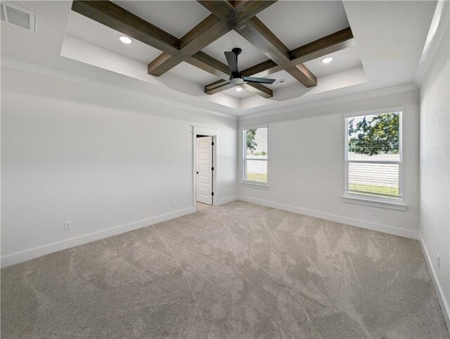 unfurnished room featuring coffered ceiling, light colored carpet, ornamental molding, ceiling fan, and beam ceiling