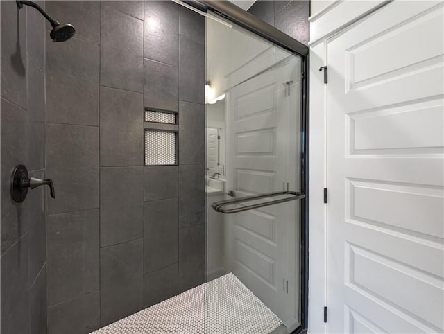 bathroom with a shower with shower door