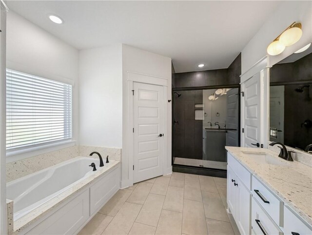 bathroom featuring vanity, tile patterned floors, and plus walk in shower