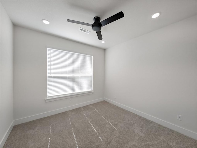 carpeted empty room featuring ceiling fan