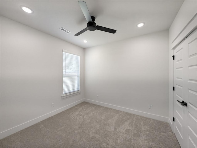 unfurnished room featuring light carpet and ceiling fan