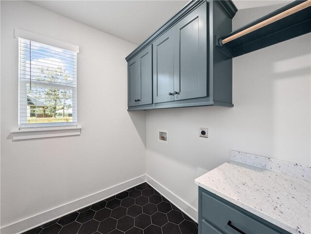 laundry area with electric dryer hookup, washer hookup, and cabinets