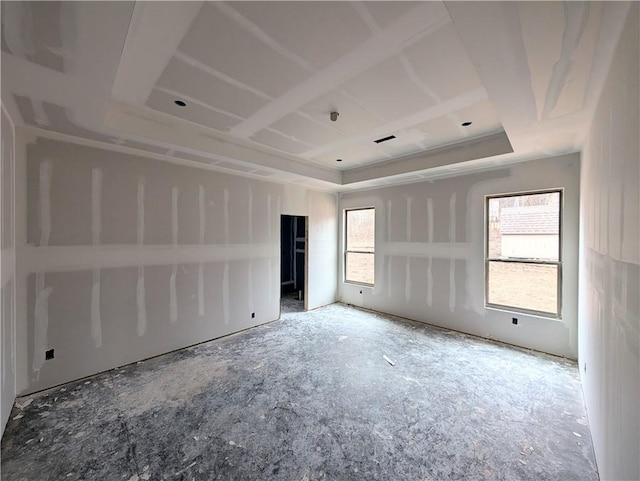 unfurnished room featuring a tray ceiling