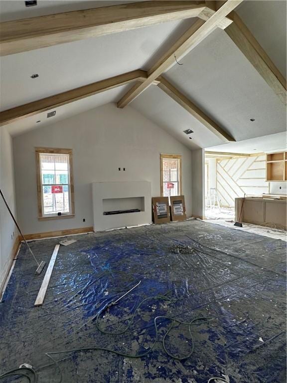 unfurnished living room with lofted ceiling with beams