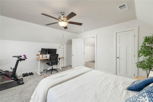 carpeted bedroom featuring lofted ceiling, a textured ceiling, and ceiling fan