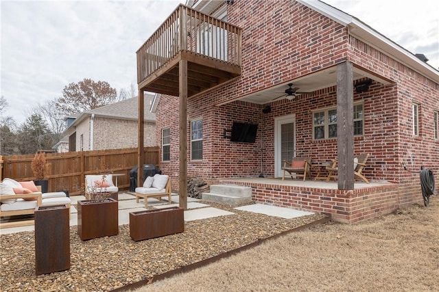 rear view of house with ceiling fan, an outdoor hangout area, a balcony, and a patio area