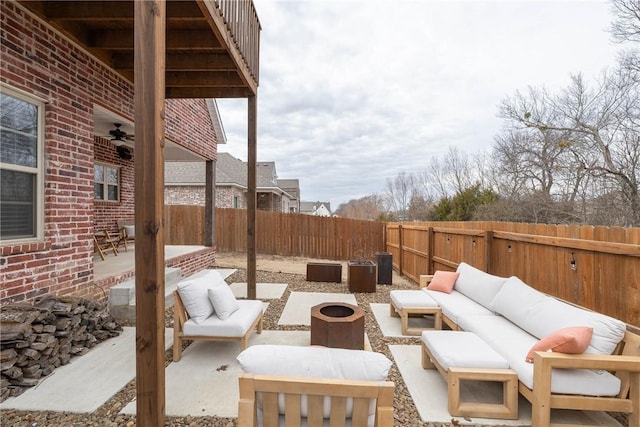 view of patio / terrace featuring an outdoor living space with a fire pit and ceiling fan